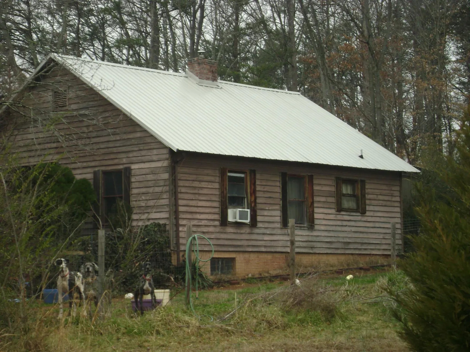 White metal roof on an old wood sided farmhouse, from a Metal Roof Installation job in Carroll
